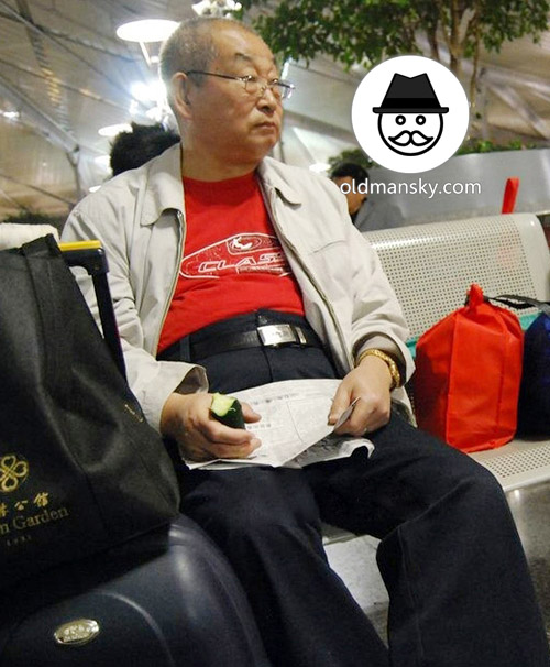 Glasses old daddy wore white jacket read newspaper in the railway station waiting room