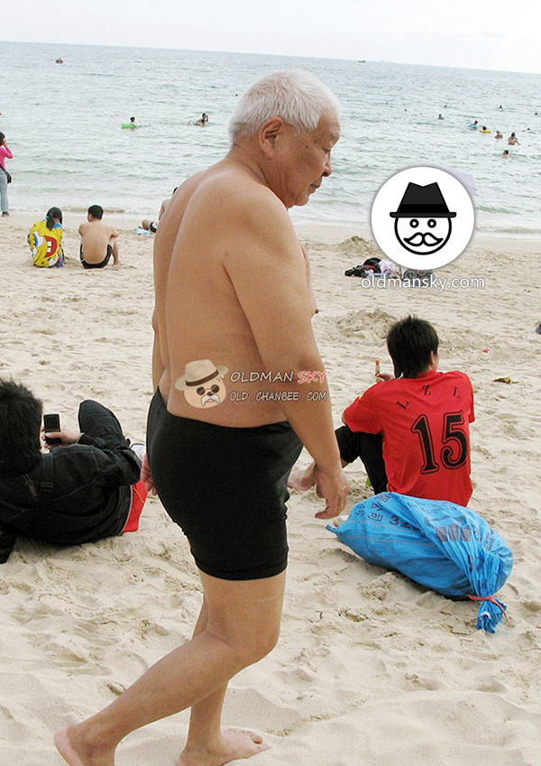 White hair old man wore blue beach pants stood at the sea