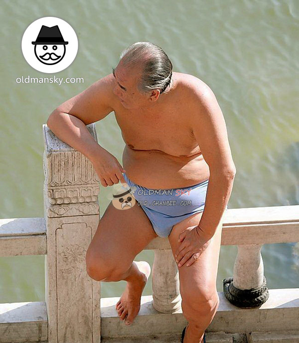 Fat swimming old man wore a blue underwear sat by the river_02